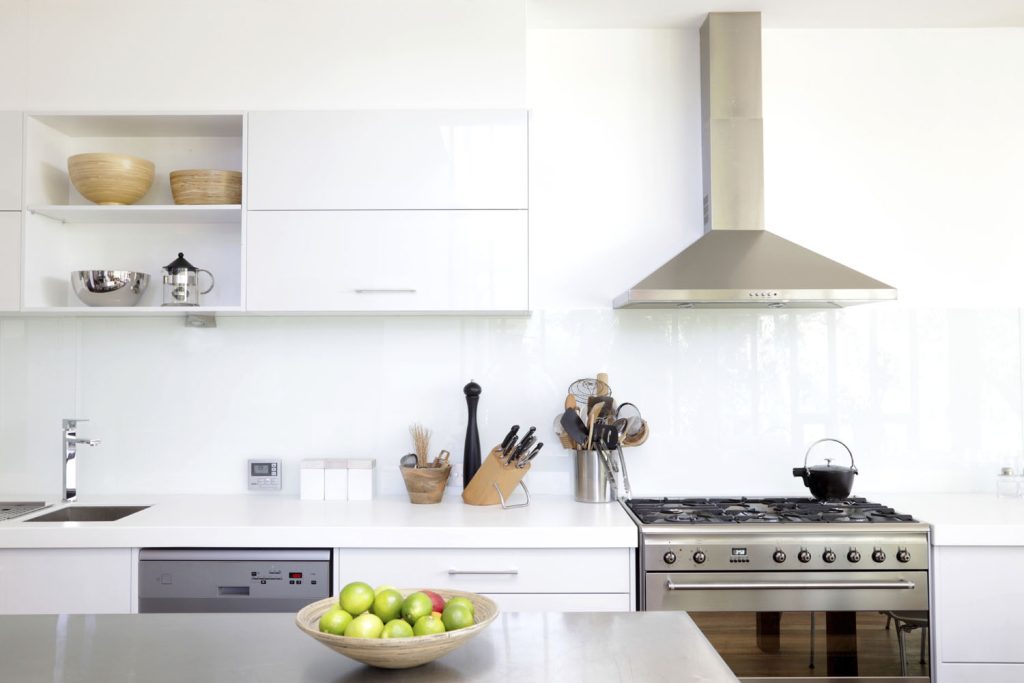 Kitchen with chrome extractor hood over chrome cooker