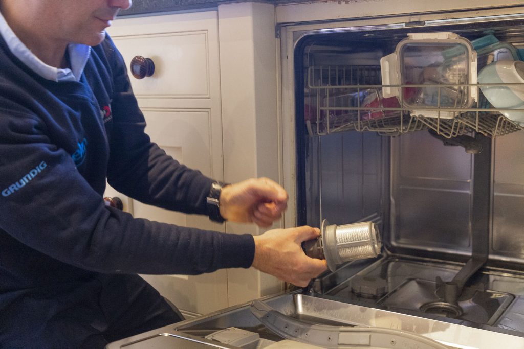 Domex engineer repairing dishwasher in Battersea