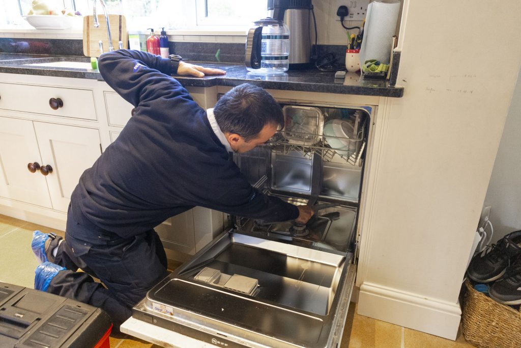 Domex engineer repairing dishwasher in Waltham Cross